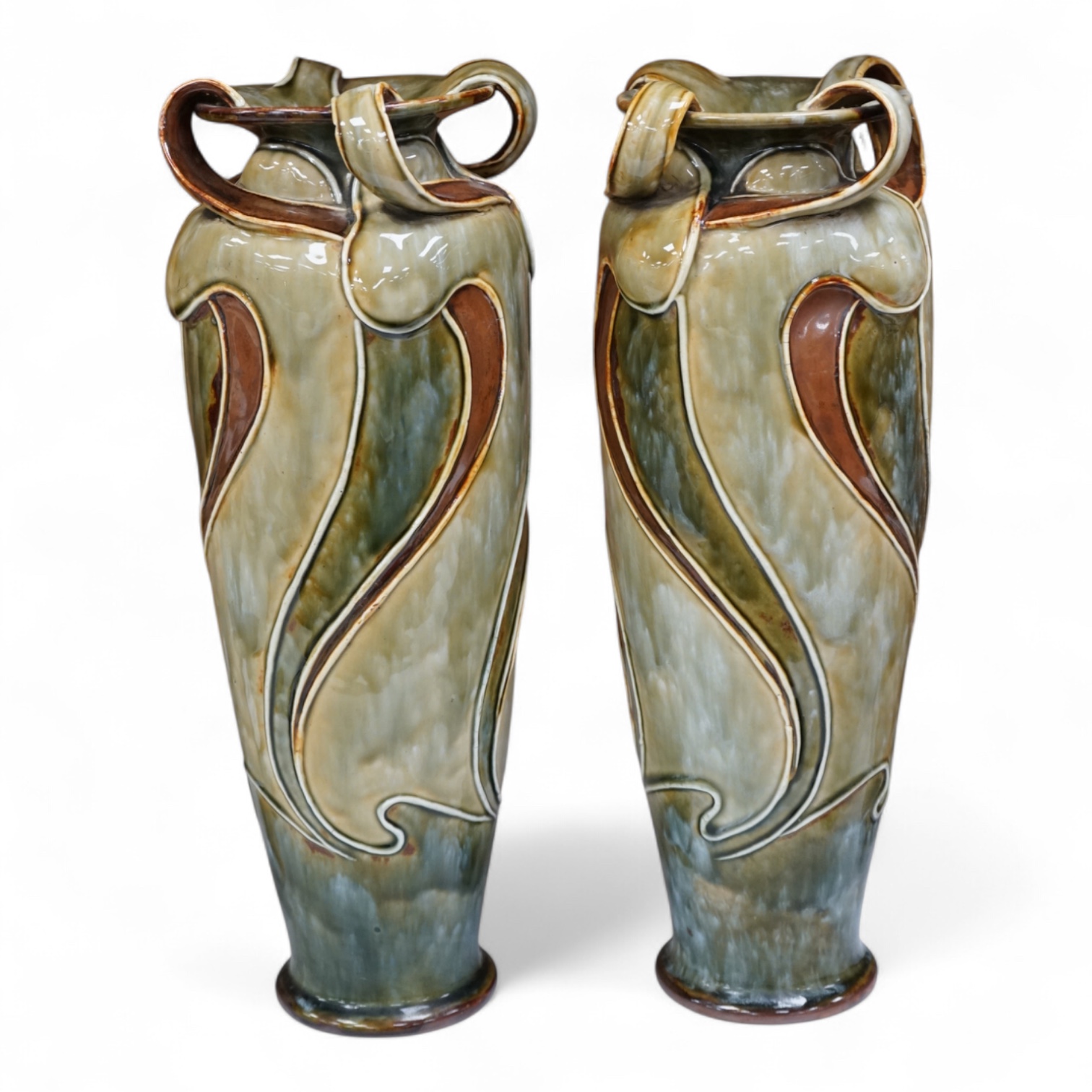 A pair of Royal Doulton, Art Nouveau vases by Frank Butler, incised and impressed marks to the bases, 37cm high